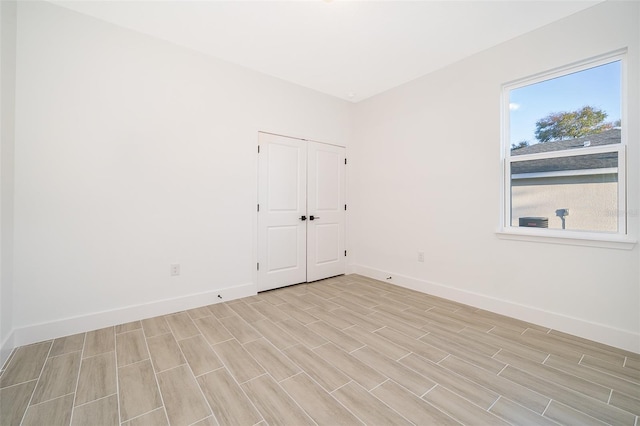 unfurnished room featuring wood finish floors and baseboards