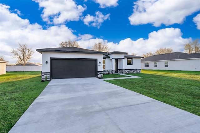 prairie-style house with an attached garage, driveway, a front lawn, and stucco siding