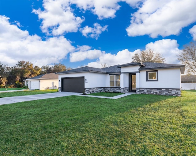 view of front of property with an attached garage, a front yard, concrete driveway, and stucco siding