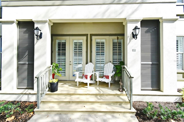 view of exterior entry featuring covered porch