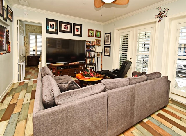 living room featuring wood-type flooring, ornamental molding, and a wealth of natural light