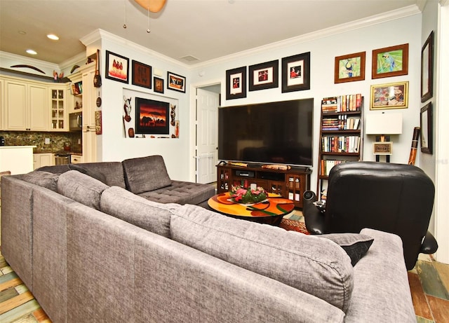 living room with hardwood / wood-style floors and crown molding