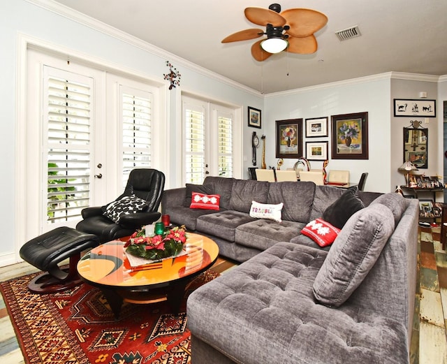 living room with wood-type flooring, plenty of natural light, and ornamental molding