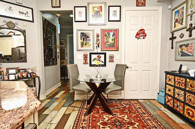 dining space with wood-type flooring