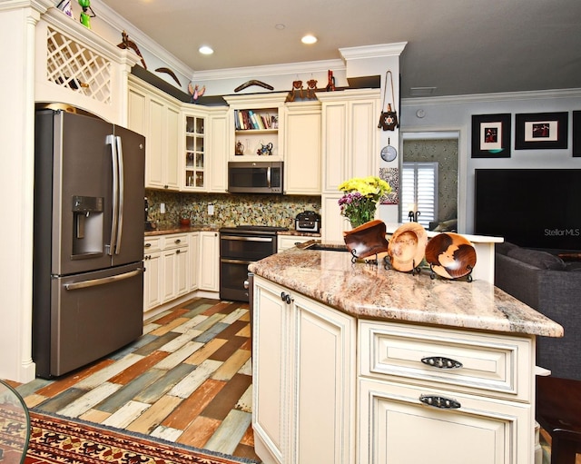 kitchen featuring light stone counters, cream cabinets, decorative backsplash, appliances with stainless steel finishes, and light wood-type flooring