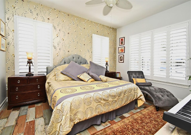 bedroom featuring multiple windows, ceiling fan, and hardwood / wood-style floors