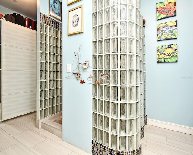 bathroom with tile patterned flooring and walk in shower