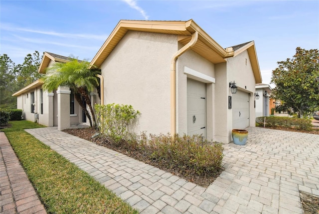 view of side of home featuring a garage