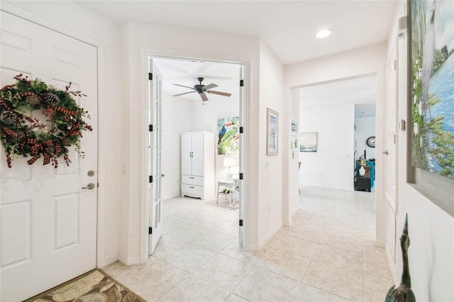 tiled entryway featuring ceiling fan