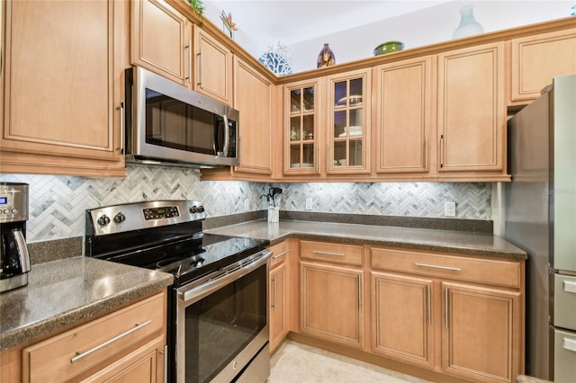 kitchen with tasteful backsplash and appliances with stainless steel finishes