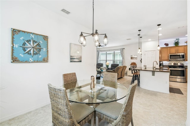 dining room with sink and an inviting chandelier