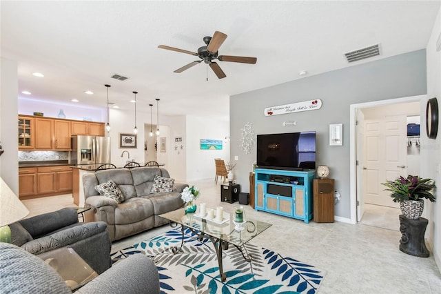 living room with ceiling fan and light tile patterned flooring