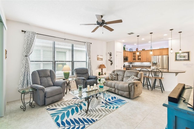 living room featuring ceiling fan and light tile patterned floors