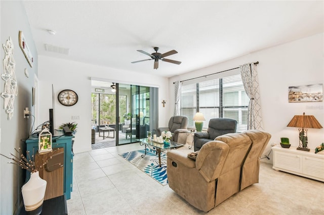 tiled living room with ceiling fan