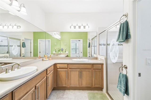 bathroom with tile patterned floors, vanity, and a shower with shower door