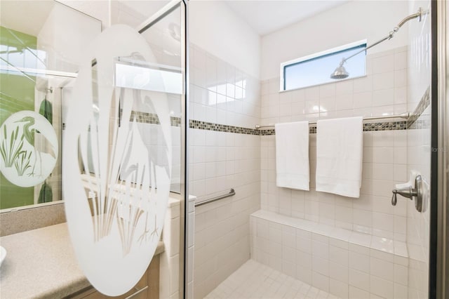 bathroom with vanity and a shower with shower door