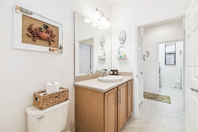 bathroom featuring tile patterned flooring, vanity, and toilet