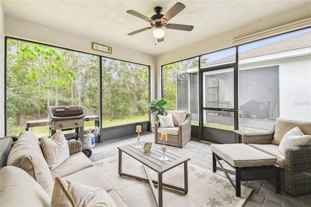 sunroom featuring ceiling fan