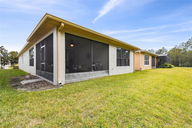 view of side of property featuring a sunroom and a lawn