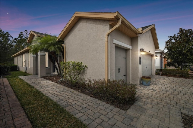 property exterior at dusk with a garage