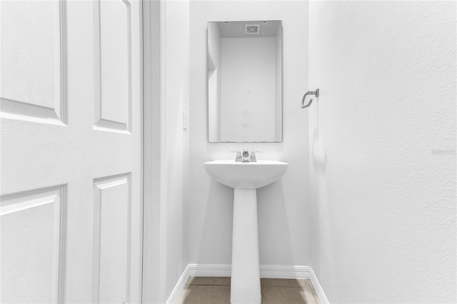 bathroom with tile patterned floors