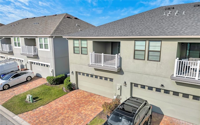 view of front of property with a garage and a balcony