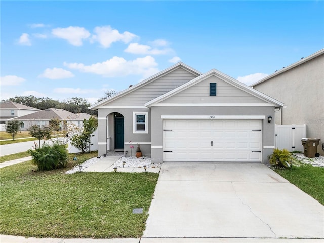 single story home featuring a garage and a front lawn