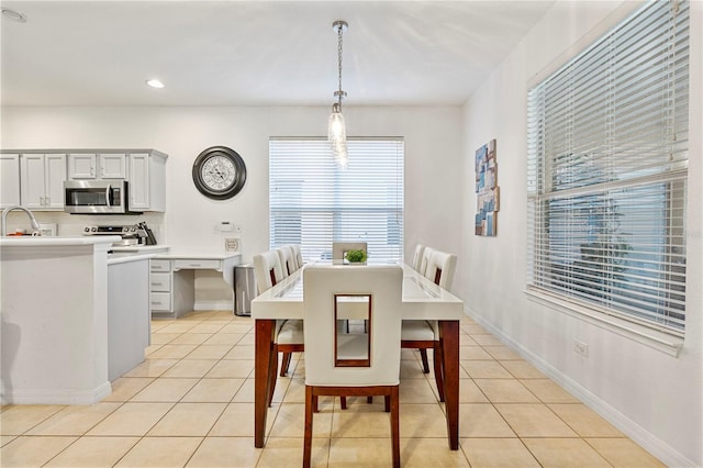 dining room featuring light tile patterned floors and sink