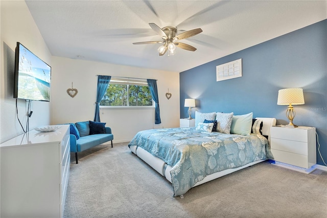 bedroom featuring ceiling fan and light colored carpet