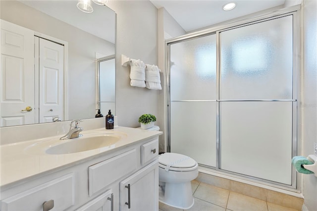 bathroom with toilet, vanity, tile patterned floors, and an enclosed shower