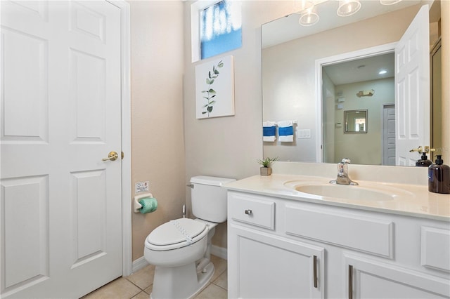 bathroom with tile patterned flooring, vanity, and toilet