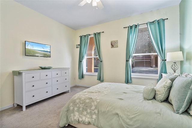 bedroom featuring light colored carpet and ceiling fan