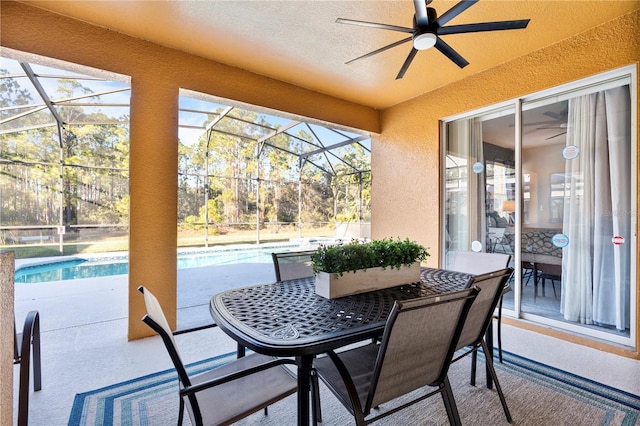 view of patio / terrace with ceiling fan and glass enclosure