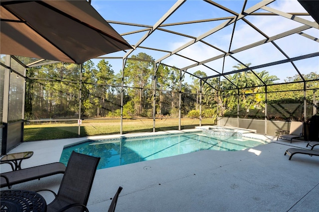 view of pool featuring glass enclosure, a patio area, and a jacuzzi