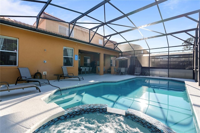 view of pool featuring a lanai, an in ground hot tub, and a patio