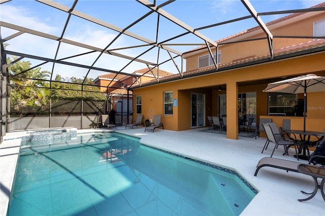 view of pool with a lanai, an in ground hot tub, and a patio