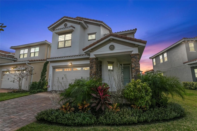 mediterranean / spanish-style home with a garage