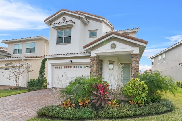 mediterranean / spanish-style home with a garage