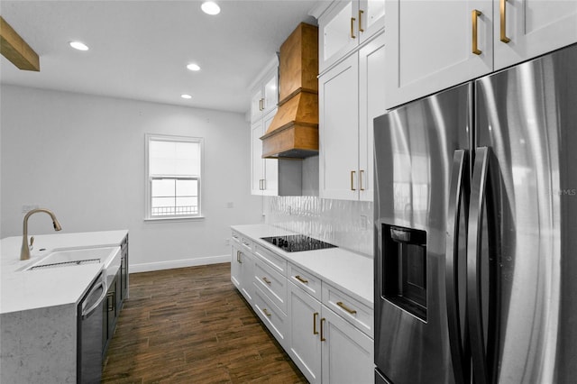 kitchen with white cabinets, appliances with stainless steel finishes, decorative backsplash, and sink