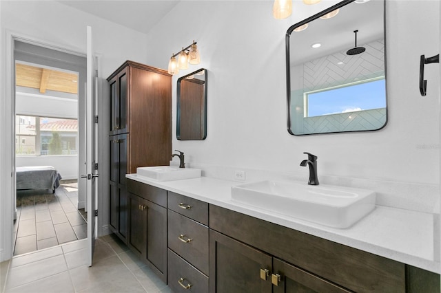 bathroom featuring tile patterned floors, vanity, and a healthy amount of sunlight