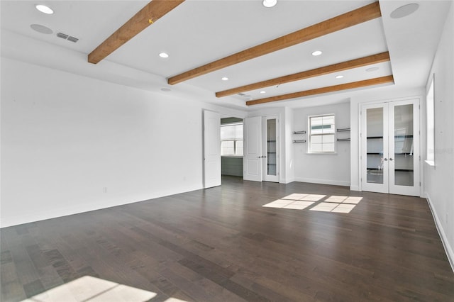 unfurnished living room with beam ceiling, dark hardwood / wood-style flooring, and french doors