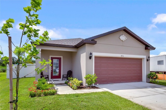 view of front of house with a garage and a front lawn