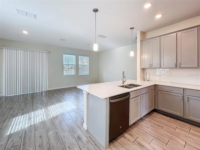 kitchen with decorative light fixtures, black dishwasher, sink, decorative backsplash, and kitchen peninsula