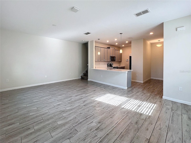 unfurnished living room with sink