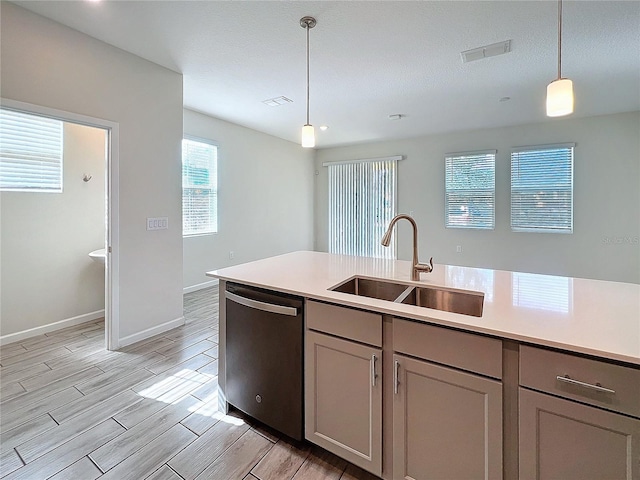 kitchen featuring gray cabinets, sink, stainless steel dishwasher, and decorative light fixtures