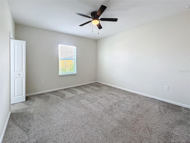 spare room with ceiling fan and carpet flooring