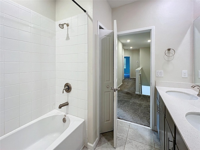 bathroom featuring tiled shower / bath, vanity, and tile patterned flooring