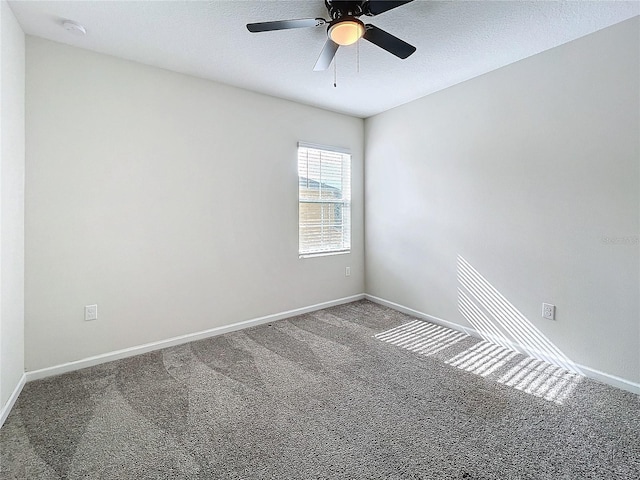 carpeted spare room with ceiling fan and a textured ceiling