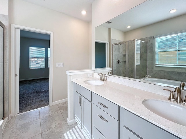 bathroom featuring tile patterned floors, vanity, and plus walk in shower