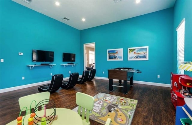 game room with dark wood-type flooring